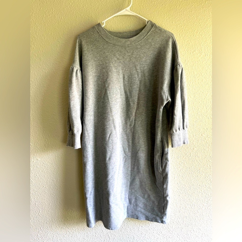Kick it with some sneakers and relax in this sweatshirt dress WITH POCKETS!